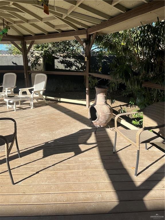 wooden deck with a gazebo and ceiling fan