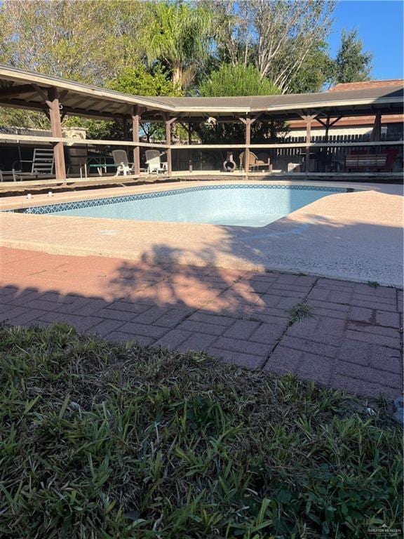 view of swimming pool with a patio