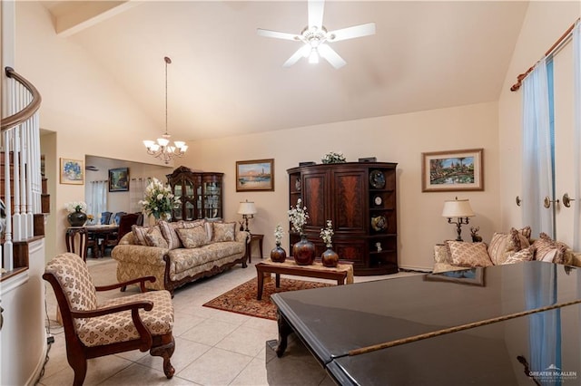 living room with ceiling fan with notable chandelier, light tile patterned floors, and high vaulted ceiling