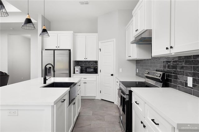2413 S Cartier Dr, Edinburg, TX 78542 - kitchen with appliances with stainless steel finishes, under cabinet range hood, tasteful backsplash, white cabinetry, and light countertops