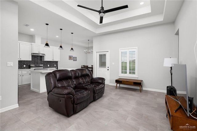 2413 S Cartier Dr, Edinburg, TX 78542 - living room featuring a ceiling fan, a chandelier, a tray ceiling, and recessed lighting