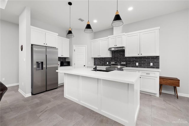 2413 S Cartier Dr, Edinburg, TX 78542 - kitchen featuring stainless steel appliances, under cabinet range hood, tasteful backsplash, white cabinetry, and recessed lighting