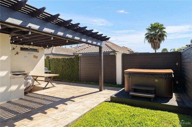 view of patio / terrace featuring a pergola, fence, and a hot tub