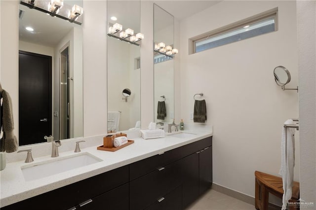 full bathroom with a sink, double vanity, and tile patterned flooring