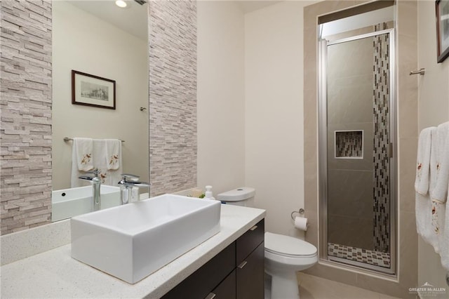 bathroom with tile patterned floors, toilet, a shower stall, and vanity