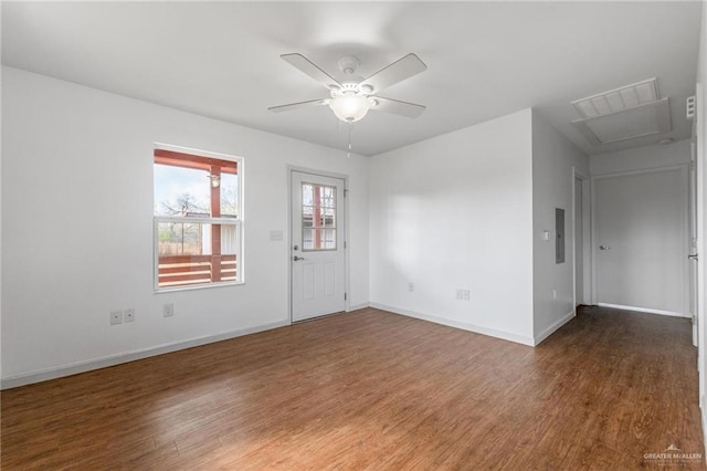 empty room with ceiling fan and dark hardwood / wood-style floors