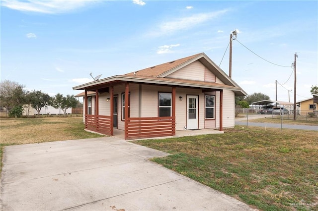 bungalow-style house featuring a front lawn and covered porch