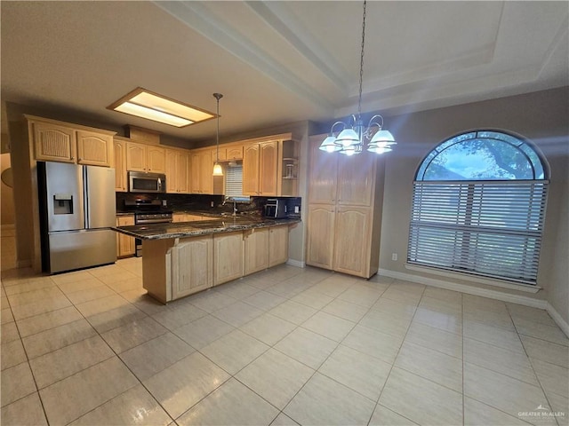 407 E Esperanza Ave, Mission, TX 78574 - kitchen with stainless steel appliances, a peninsula, a kitchen breakfast bar, light tile patterned floors, and a tray ceiling