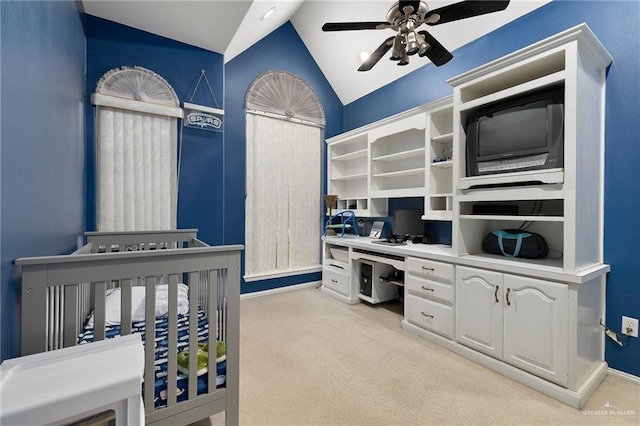 carpeted bedroom with ceiling fan and vaulted ceiling