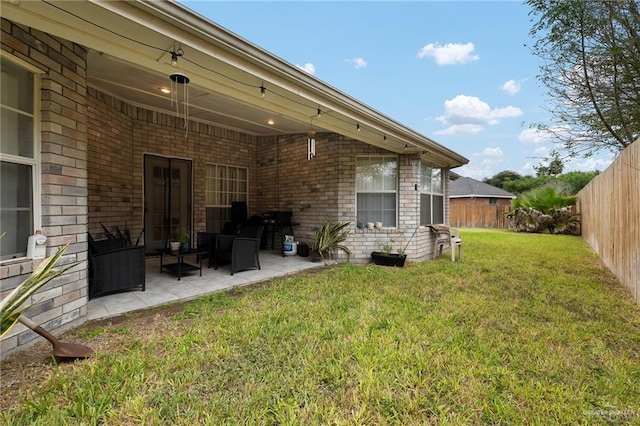 rear view of house with a lawn and a patio area