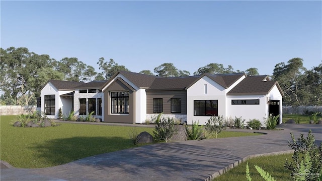 modern farmhouse style home with a front lawn, concrete driveway, and an attached garage