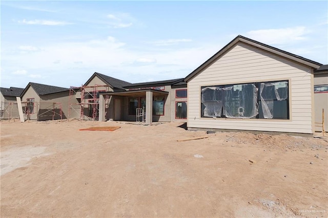 rear view of property with fence