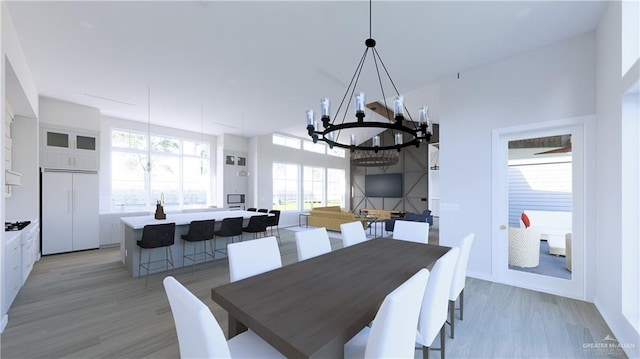 dining room featuring light wood finished floors and an inviting chandelier