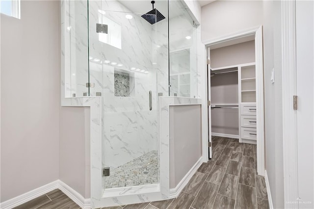 3303 Alcatraz St, Edinburg, TX 78542 - full bath featuring a marble finish shower, a walk in closet, wood finish floors, and baseboards