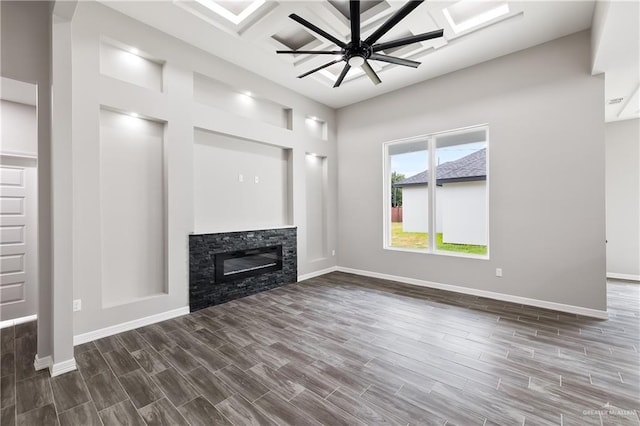 3303 Alcatraz St, Edinburg, TX 78542 - unfurnished living room with ceiling fan, a stone fireplace, baseboards, dark wood-type flooring, and coffered ceiling