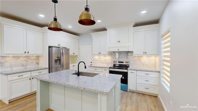 kitchen with stainless steel appliances, sink, white cabinets, and decorative light fixtures