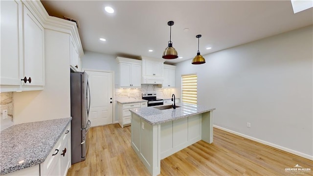 kitchen with appliances with stainless steel finishes, pendant lighting, light stone countertops, a kitchen island with sink, and white cabinets