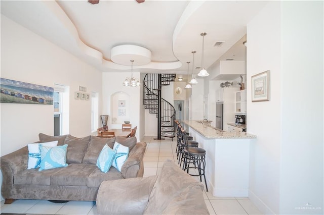 112 E Acapulco St E Unit 3, South Padre Island, TX 78597 - living room with light tile patterned floors, arched walkways, and a tray ceiling