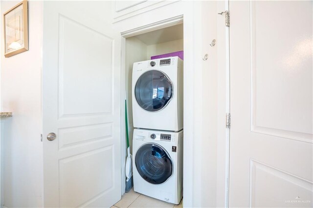 112 E Acapulco St E Unit 3, South Padre Island, TX 78597 - laundry area featuring stacked washer / dryer and light tile patterned flooring