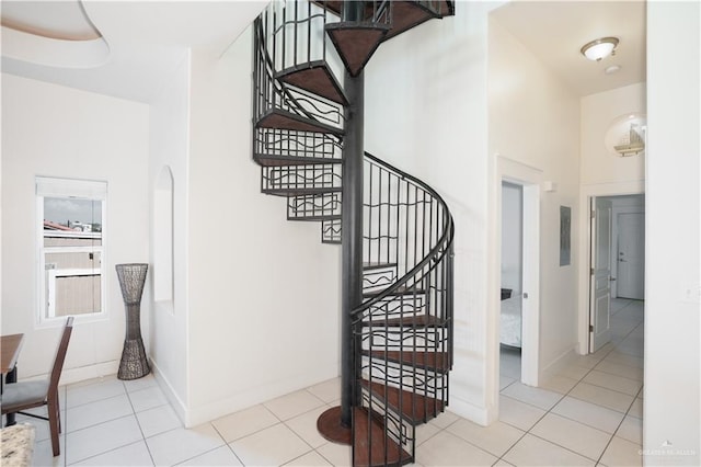 112 E Acapulco St E Unit 3, South Padre Island, TX 78597 - stairs with tile patterned flooring and baseboards