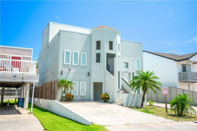 112 E Acapulco St E Unit 3, South Padre Island, TX 78597 - view of front of house featuring stucco siding and stairs