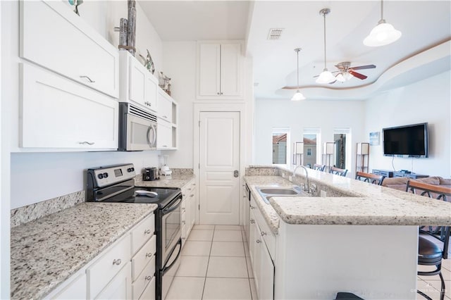 112 E Acapulco St E Unit 3, South Padre Island, TX 78597 - kitchen featuring appliances with stainless steel finishes, a sink, a breakfast bar, ceiling fan, and open floor plan