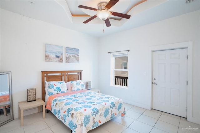 112 E Acapulco St E Unit 3, South Padre Island, TX 78597 - bedroom featuring light tile patterned floors, a tray ceiling, ceiling fan, and baseboards