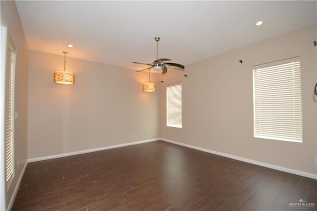 empty room featuring dark hardwood / wood-style flooring and ceiling fan