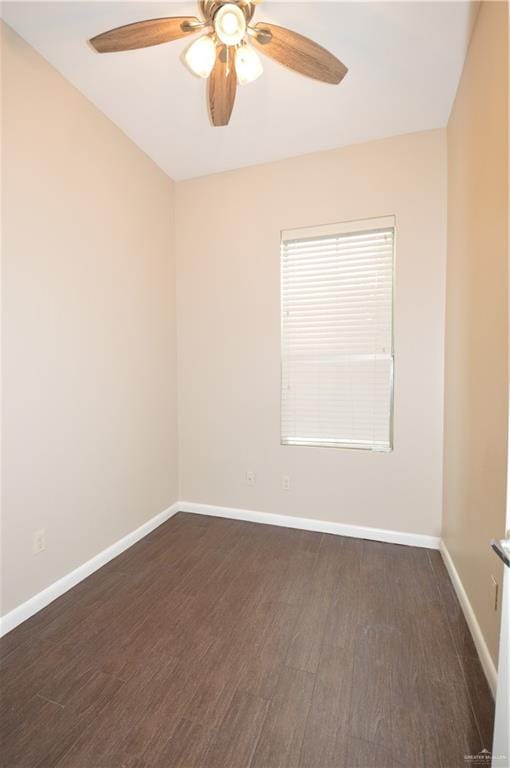 empty room with dark hardwood / wood-style floors and ceiling fan