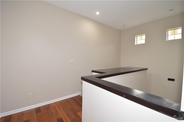 corridor featuring dark hardwood / wood-style floors