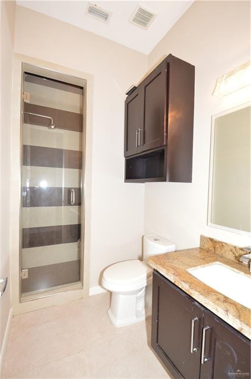 bathroom with tile patterned floors, vanity, toilet, and an enclosed shower