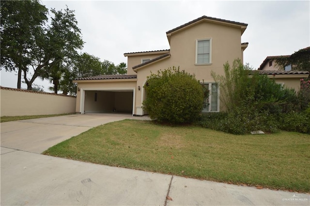 mediterranean / spanish home with a garage and a front lawn