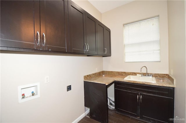 washroom with cabinets, washer hookup, and sink