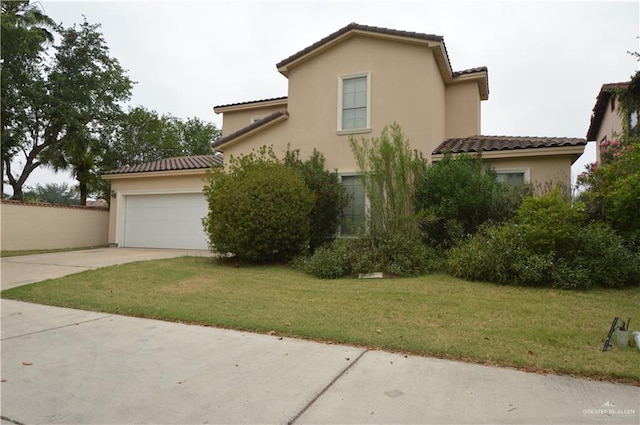 view of front of house featuring a front yard and a garage