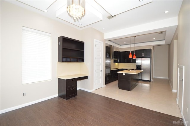 kitchen with dark hardwood / wood-style flooring, stainless steel appliances, decorative light fixtures, a notable chandelier, and a center island