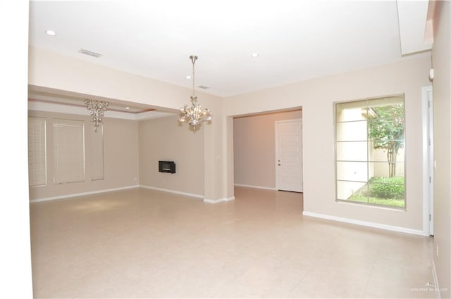 empty room with an inviting chandelier