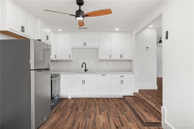 kitchen featuring white cabinetry, electric range oven, stainless steel fridge, and sink