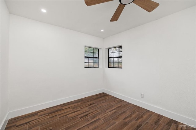 spare room with dark wood-type flooring and ceiling fan