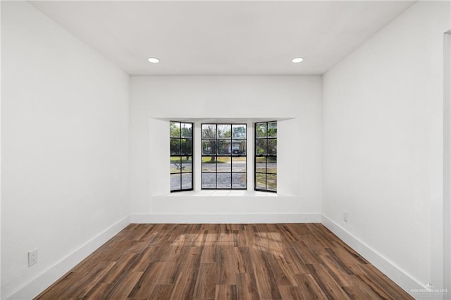 empty room with hardwood / wood-style flooring