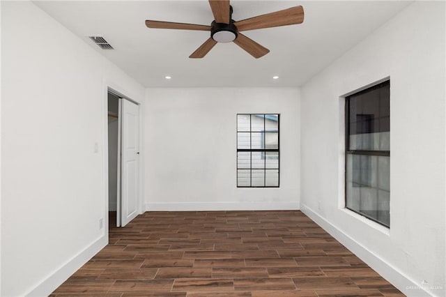 unfurnished room with dark hardwood / wood-style flooring and ceiling fan