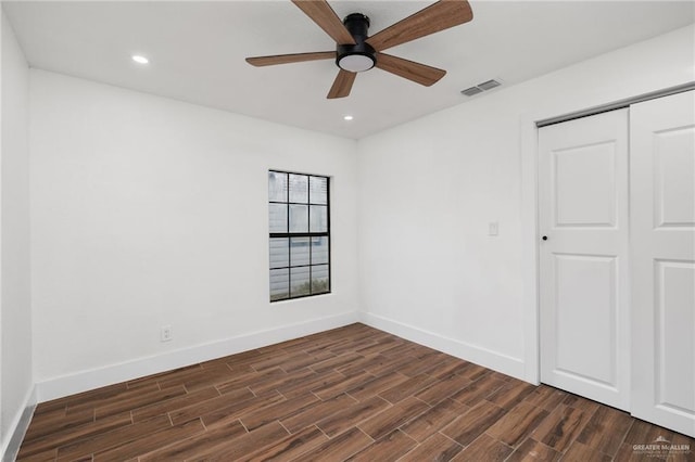 unfurnished bedroom with ceiling fan, dark hardwood / wood-style flooring, and a closet