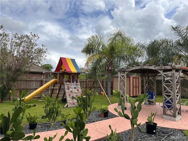 view of playground featuring a lawn, a patio area, and a pergola