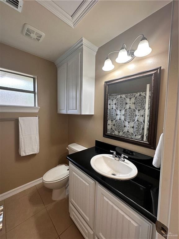 bathroom featuring tile patterned floors, toilet, vanity, and ornamental molding