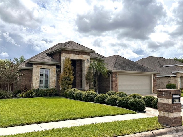 view of front of property featuring a front yard and a garage