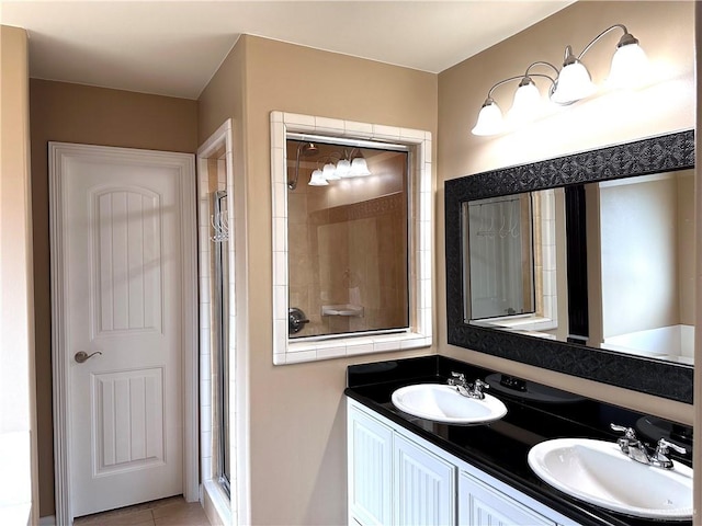 bathroom with vanity, tile patterned floors, and a shower with shower door