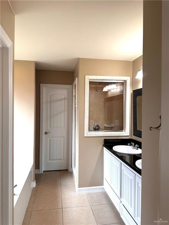 bathroom featuring a bath, vanity, and tile patterned floors