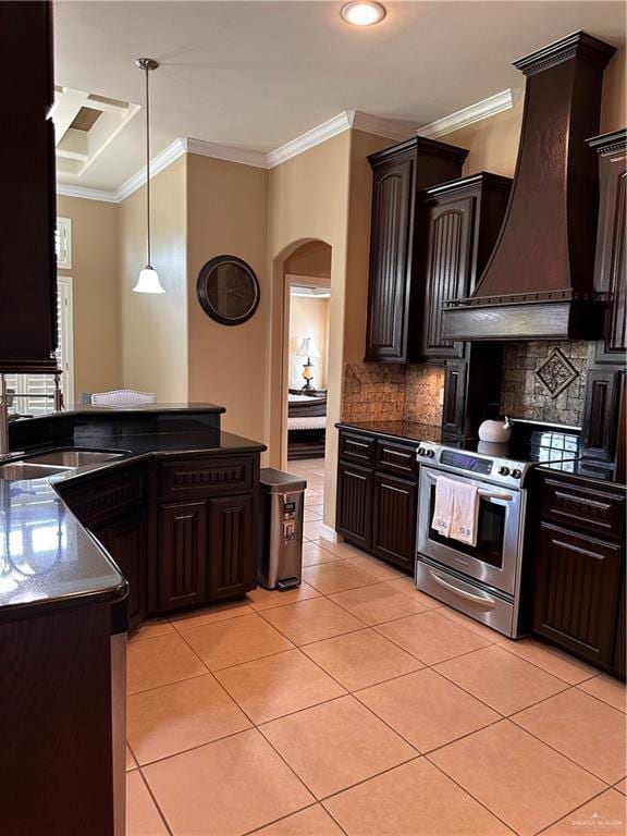 kitchen with ornamental molding, custom range hood, pendant lighting, stainless steel range with electric cooktop, and light tile patterned flooring