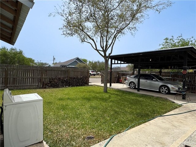 view of yard with washer / dryer and fence