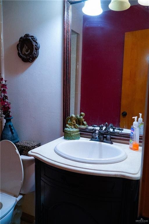 bathroom featuring vanity and toilet
