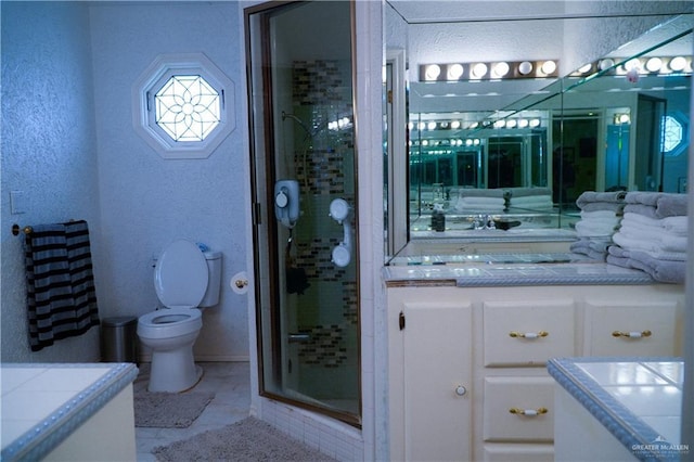 bathroom with toilet, vanity, a stall shower, and a textured wall